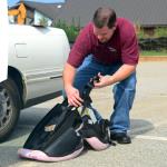 Sheriff Thomas checking a child safety seat at the Child Safety Day at the Madison County Senior Center.